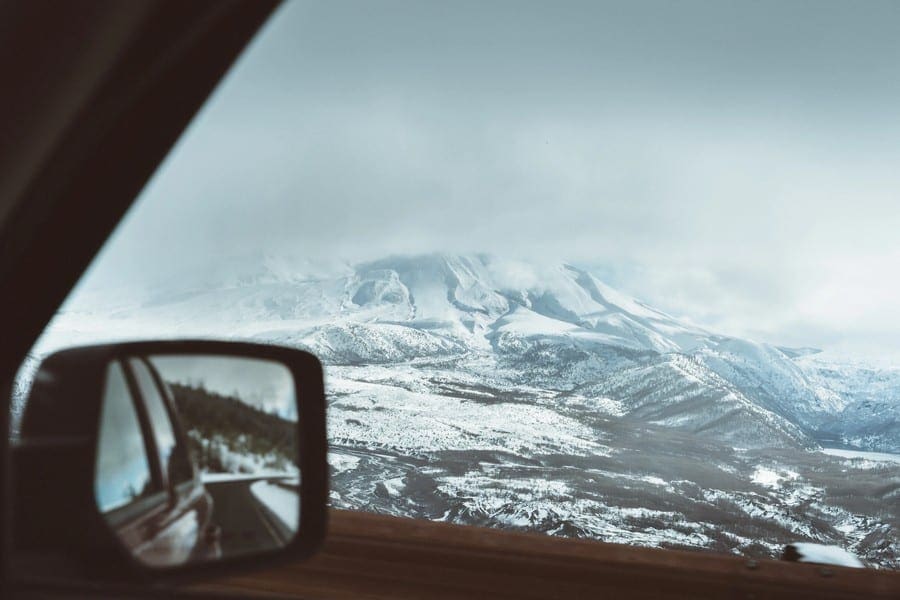 Met de auto op wintersport. uitzicht op besneeuwde bergen.