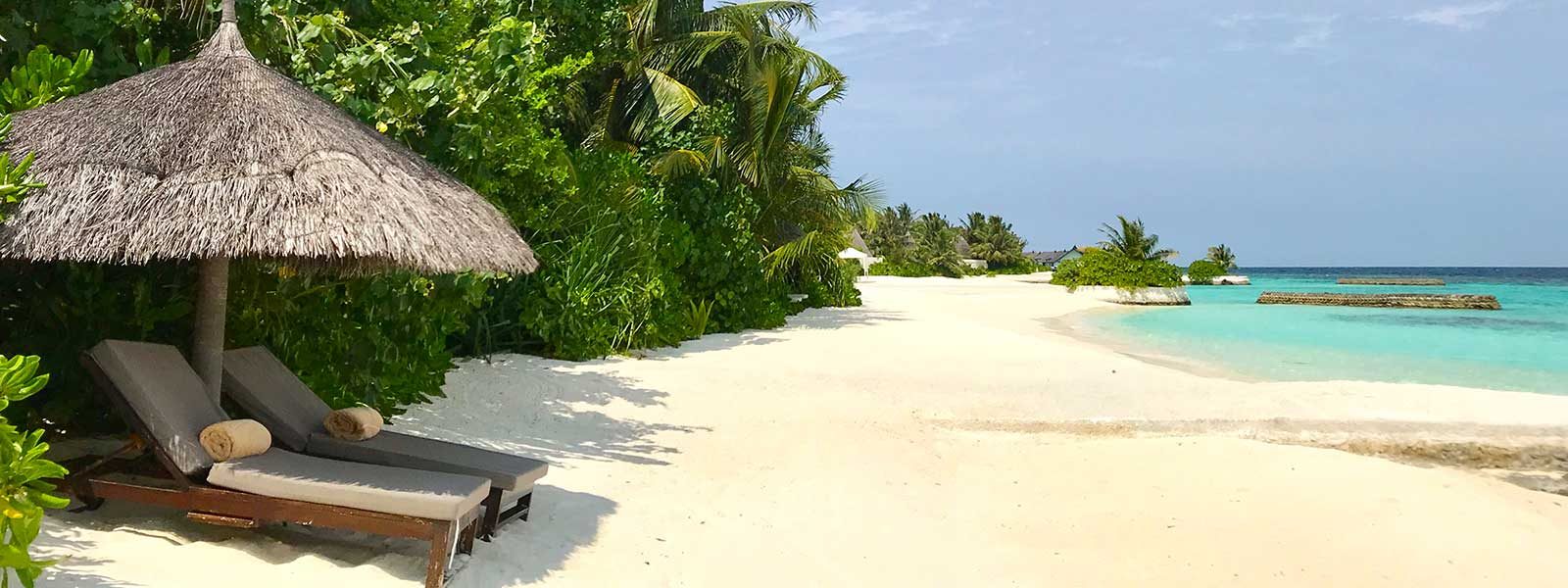 Ligbedden op het strand van het resort op Bolifushi